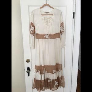White and mesh mid length dress with sleeves.